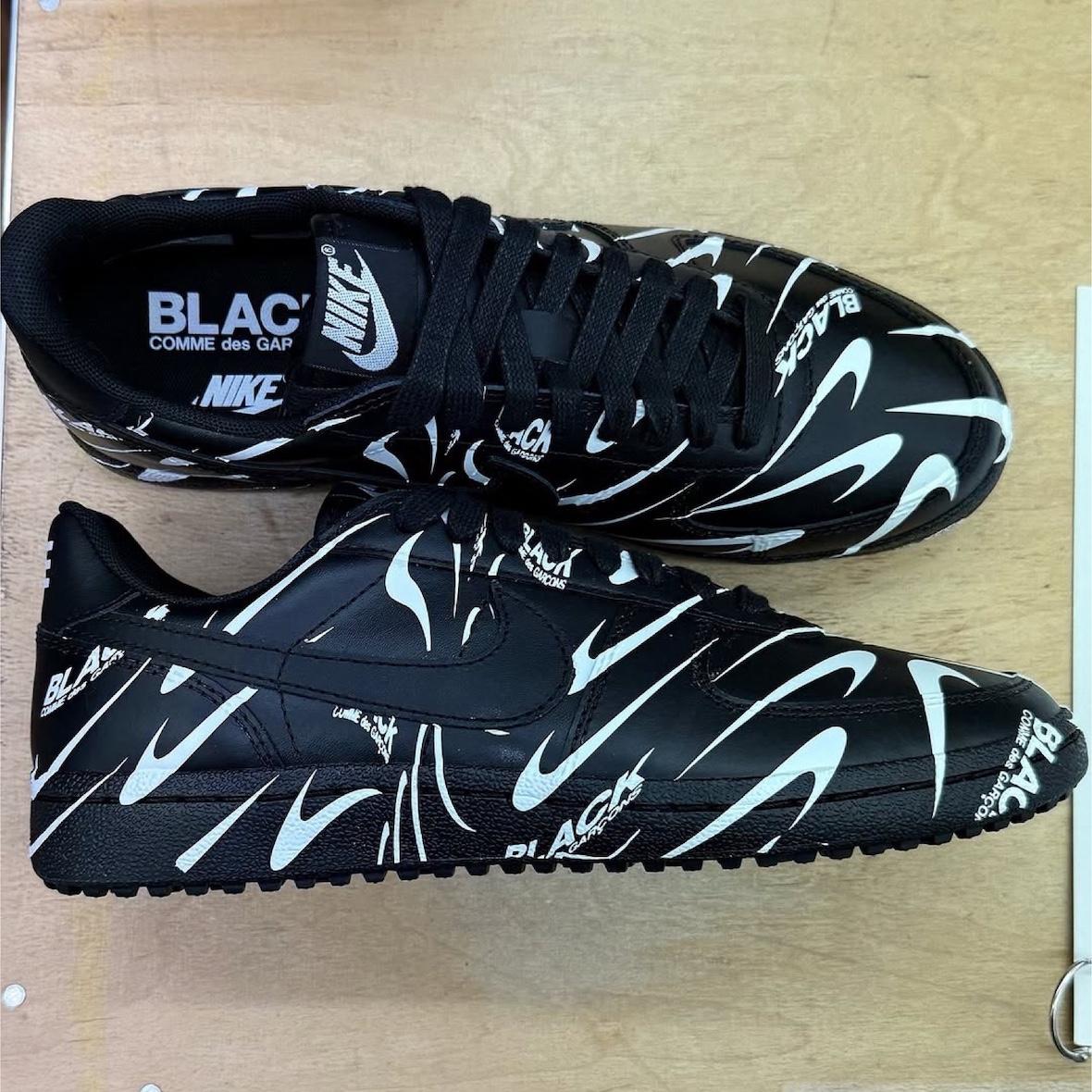 Side profile of the Comme des Garçons BLACK x Nike Field General 82 showcasing the wavy logo design. Side profile of the Comme des Garçons BLACK x Nike Field General 82 showcasing the wavy logo design.