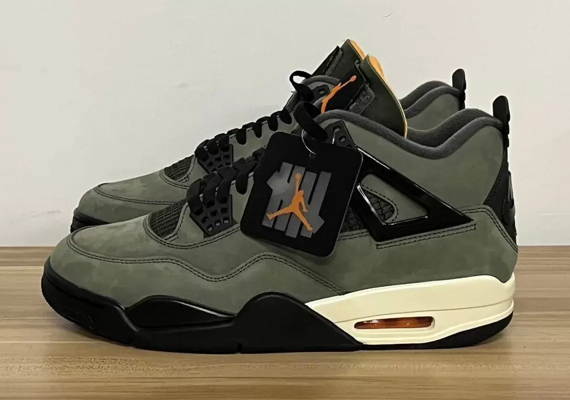 Side view of the Undefeated Air Jordan 4 in Deep Green with hangtag, releasing June 2025 Side view of the Undefeated Air Jordan 4 in Deep Green with hangtag, releasing June 2025