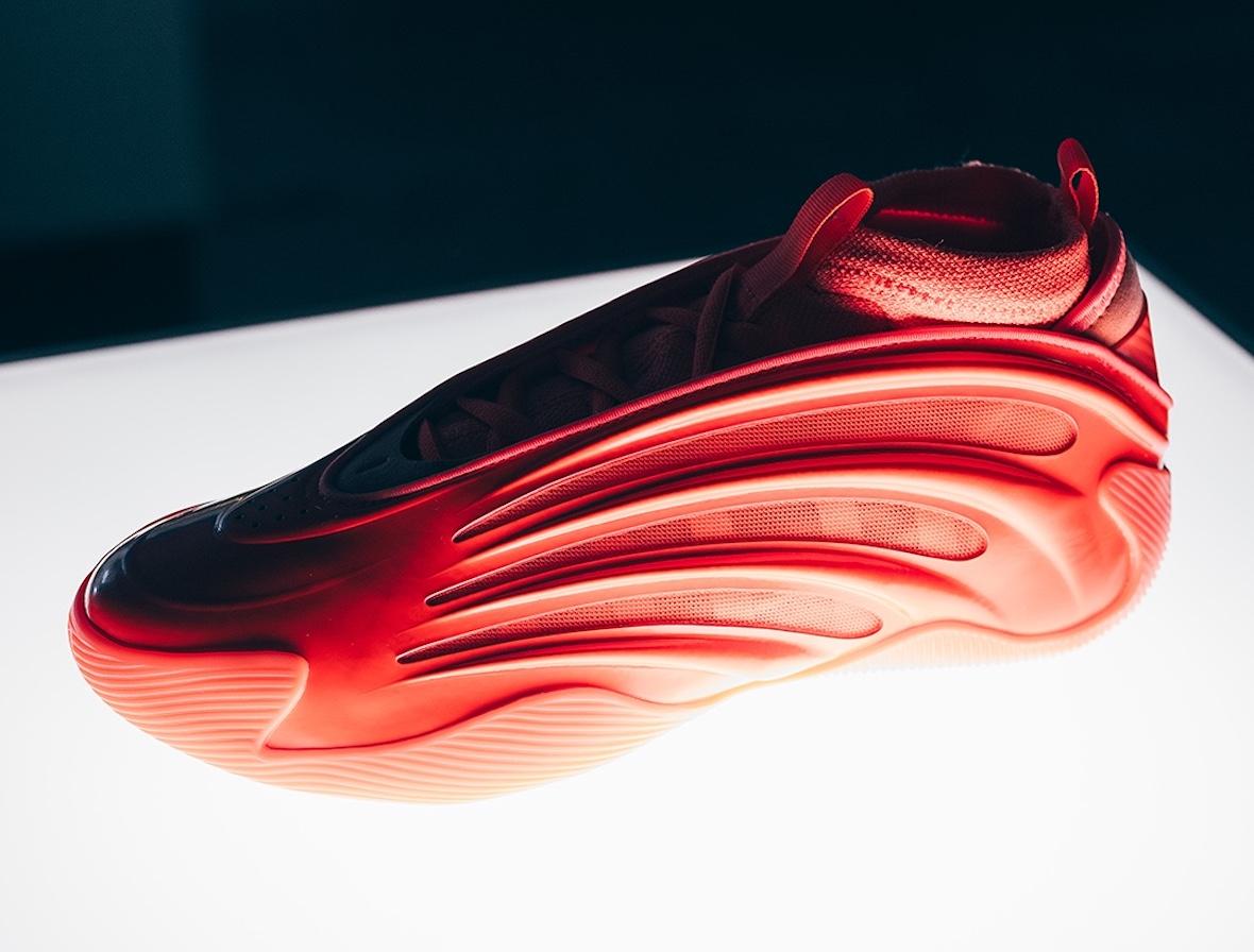 The adidas Harden Vol 9 Dynamo in bright orange, displayed under spotlight. The adidas Harden Vol 9 Dynamo in bright orange, displayed under spotlight.