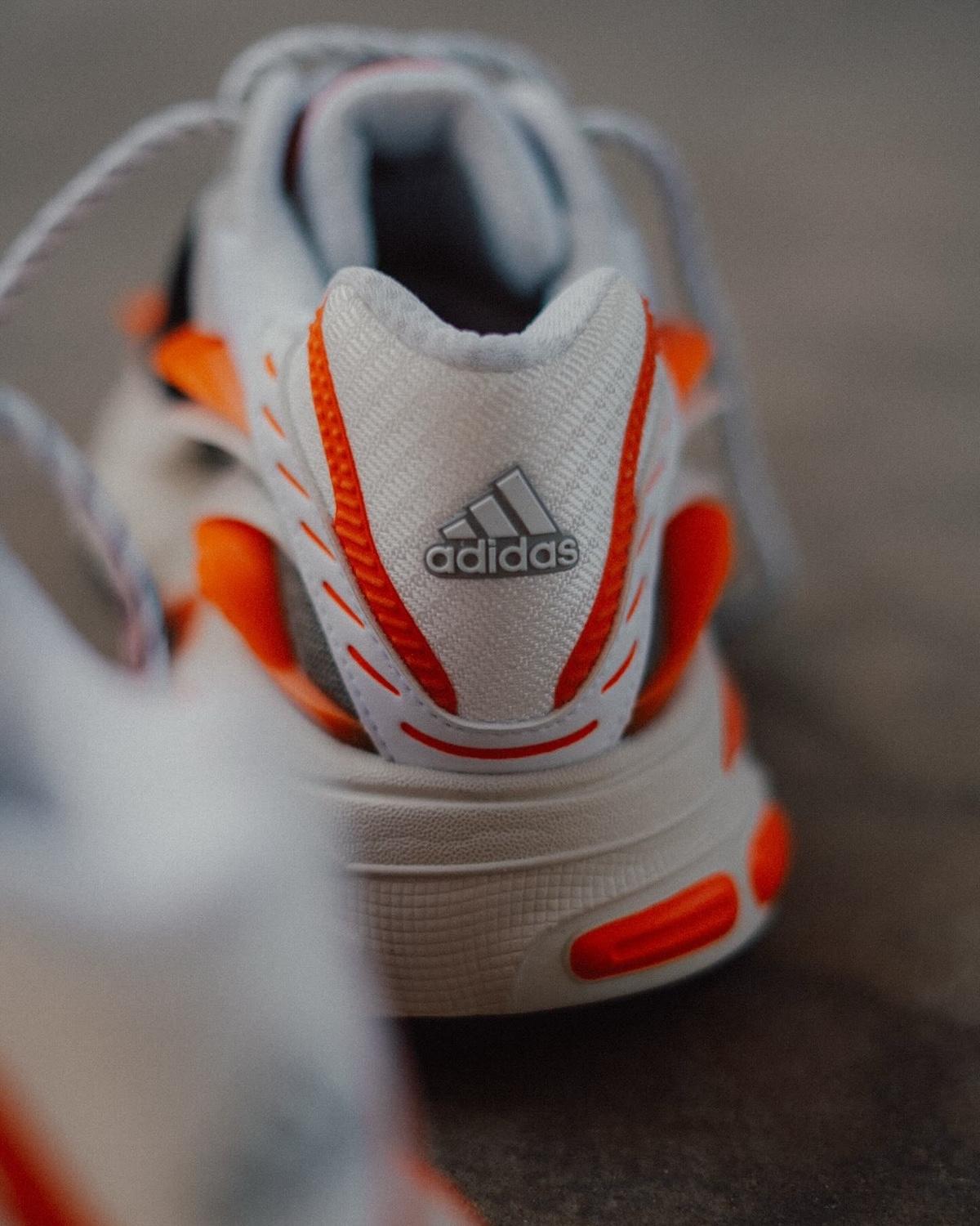 Pharrell x adidas Adistar Jellyfish Heel Branding – A rear view of the sneaker with the adidas logo on the heel, surrounded by bold orange and black details. Pharrell x adidas Adistar Jellyfish Heel Branding – A rear view of the sneaker with the adidas logo on the heel, surrounded by bold orange and black details.