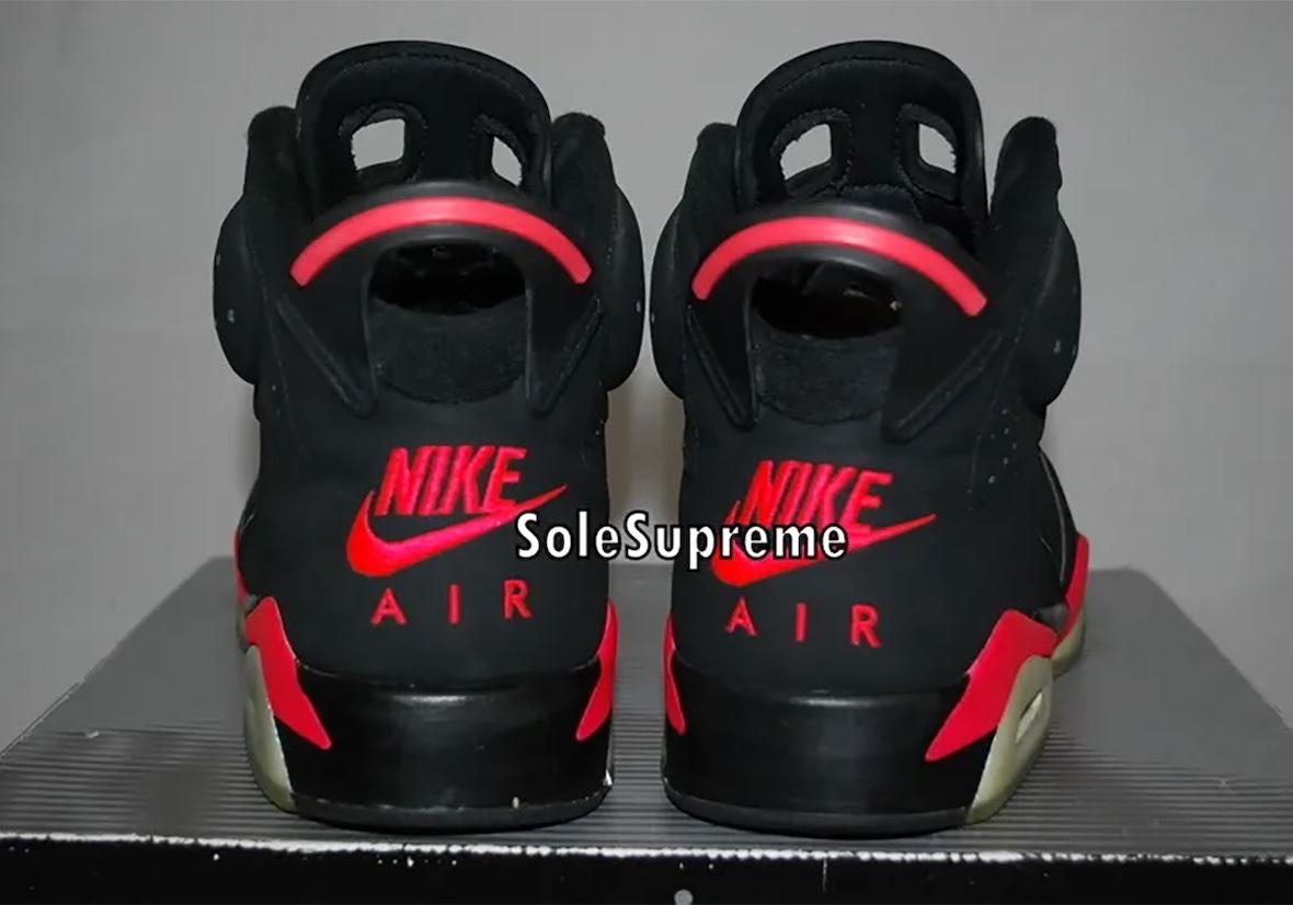 Close-up of the Air Jordan 6 Reverse Infrared original sample showcasing black nubuck uppers, vibrant infrared midsole accents, and icy aged outsoles displayed on top of the retro-style Jordan box. Close-up of the Air Jordan 6 Reverse Infrared original sample showcasing black nubuck uppers, vibrant infrared midsole accents, and icy aged outsoles displayed on top of the retro-style Jordan box.