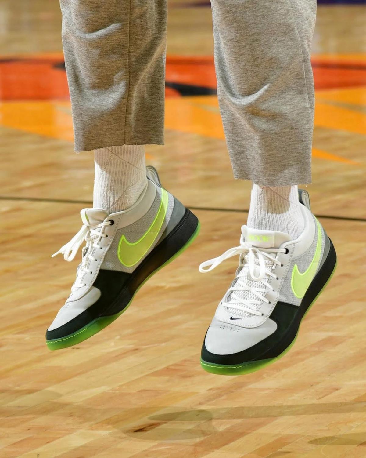 Nike Book 1 Neon sneaker mid-air, showcasing Neon Volt details. Nike Book 1 Neon sneaker mid-air, showcasing Neon Volt details.