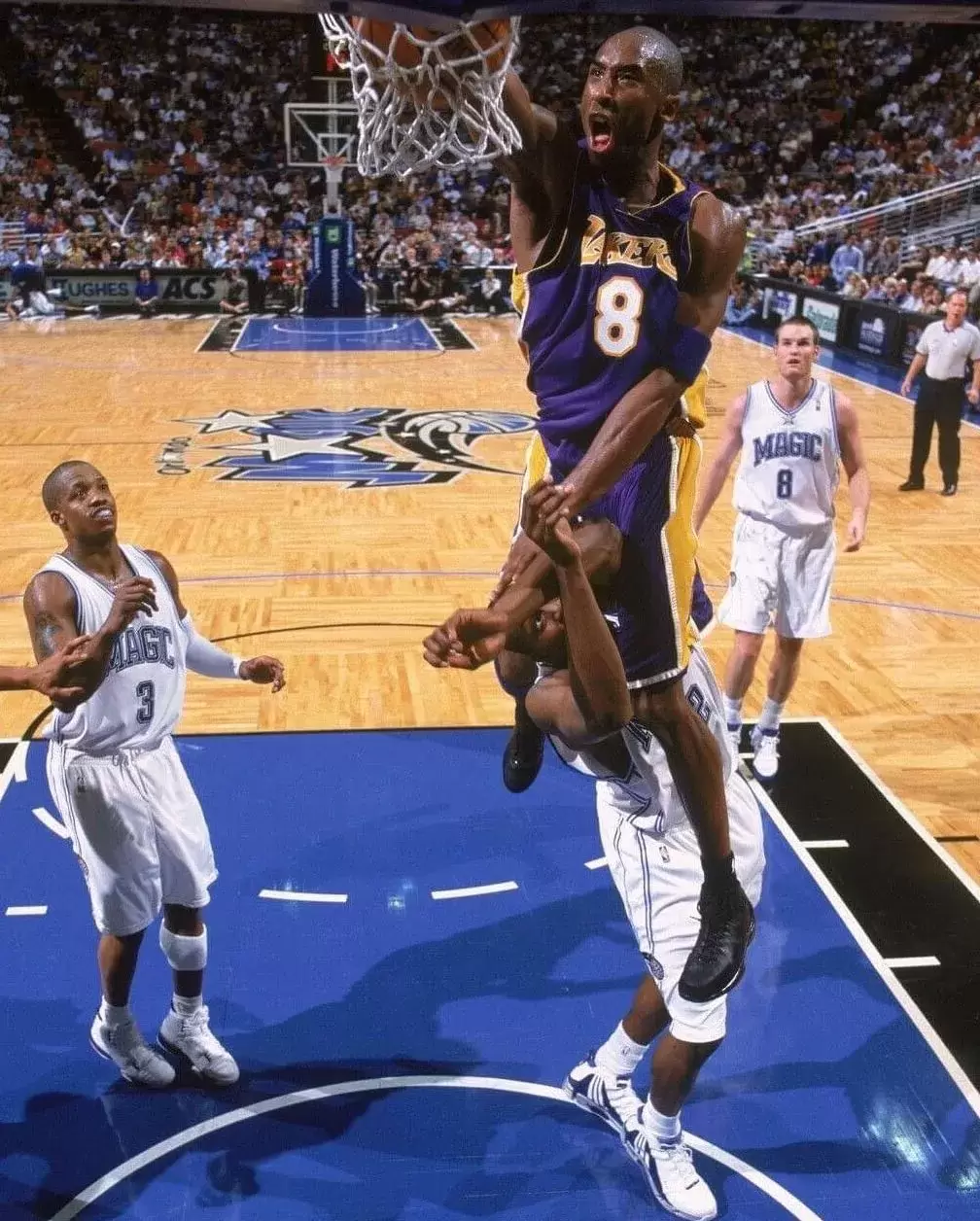 Kobe Bryant of the Los Angeles Lakers dunks over Dwight Howard of the Orlando Magic during a 2004 NBA game. Kobe Bryant of the Los Angeles Lakers dunks over Dwight Howard of the Orlando Magic during a 2004 NBA game.