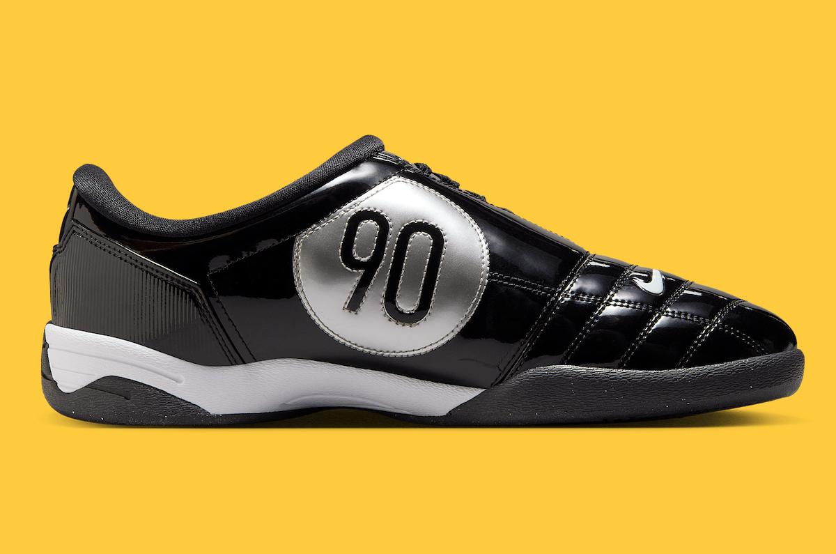 Side profile of the Nike Total 90 III Black Patent, highlighting the oversized "90" emblem in silver, black patent leather upper, and sleek white midsole. Side profile of the Nike Total 90 III Black Patent, highlighting the oversized "90" emblem in silver, black patent leather upper, and sleek white midsole.