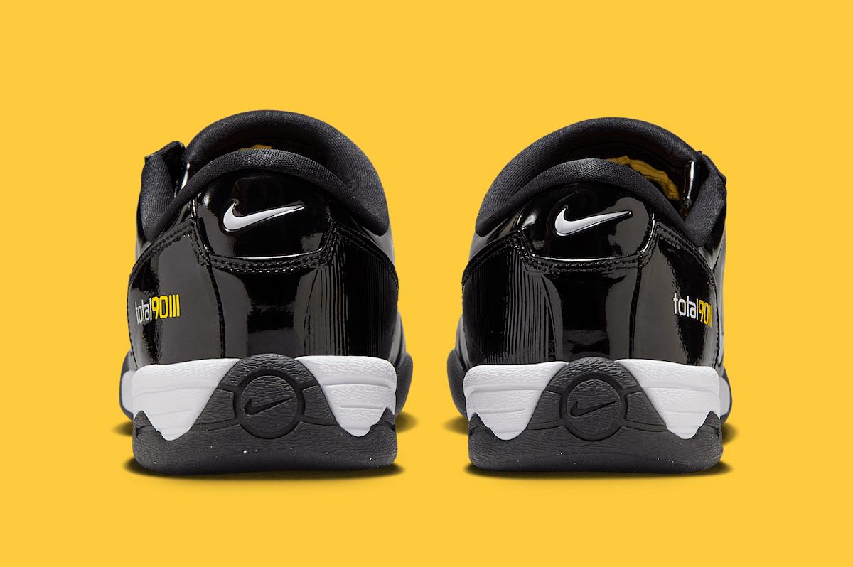 Rear view of the Nike Total 90 III Black Patent, showcasing the back heel details with Total 90 branding, a mini white Swoosh, and a black and white midsole design. Rear view of the Nike Total 90 III Black Patent, showcasing the back heel details with Total 90 branding, a mini white Swoosh, and a black and white midsole design.